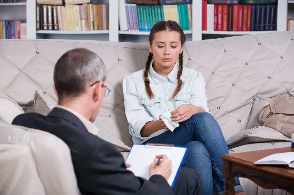 Woman in therapy discussing mental and emotional well being